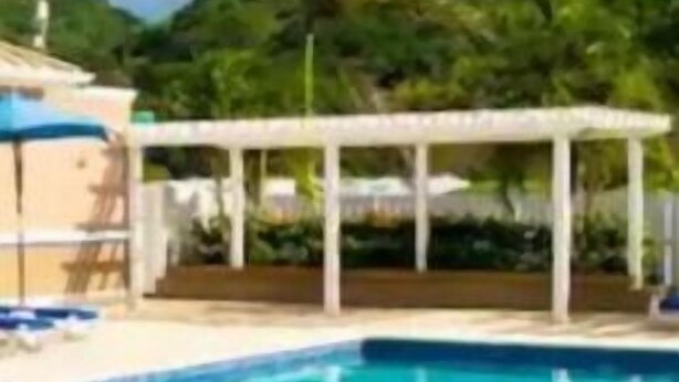 A swimming pool with a white canopy and lounge chairs. - Le-Rendezvous A Charming 2 Bedroom 2 Bath home (Lucea)
