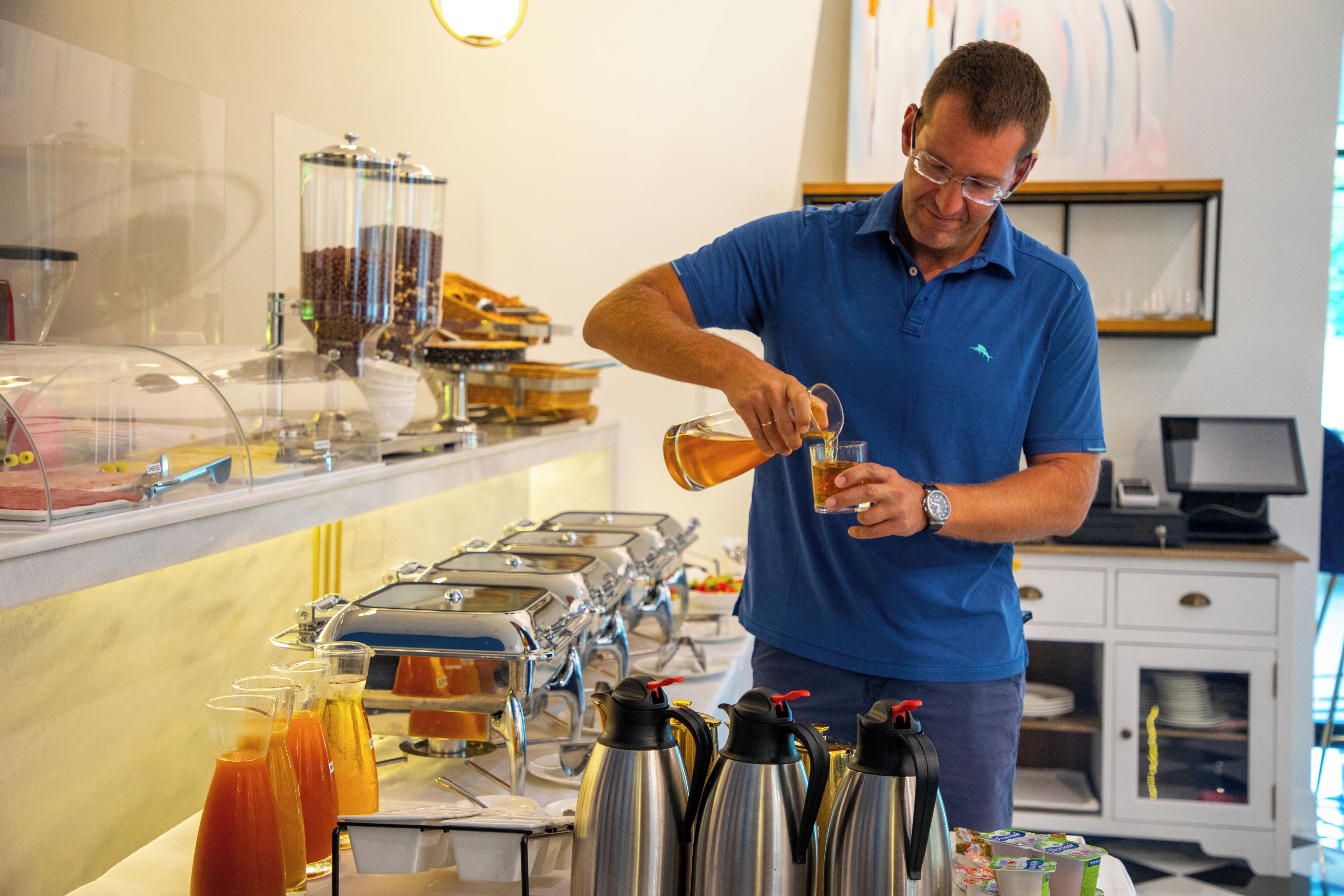 A buffet setup with various food items and beverages.