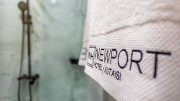A close-up of a towel with the text "NEWPORT HOTEL" and "KUTAIS" on it.