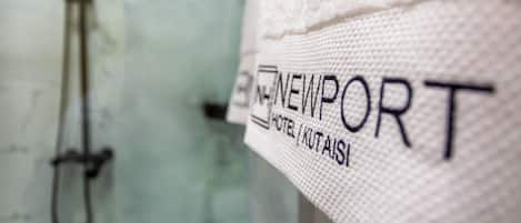 A close-up of a towel with the text "NEWPORT HOTEL" and "KUTAIS" on it.
