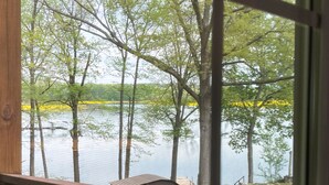 A view from a window overlooking a lake with trees and a dock. - Lake Front, Sunrise, Dock, Kayaks + Game Room (Cadiz)