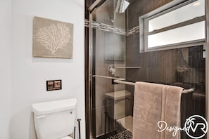 A modern bathroom with a glass shower enclosure, a white toilet, and a towel rack. - 6 BR With Heated Pool Close to Beach (Pompano Beach)