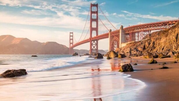 A coastal scene with a prominent red bridge, rocky beach, and ocean waves. - Large home - Sleeps many 4B/2B (Walnut Creek)