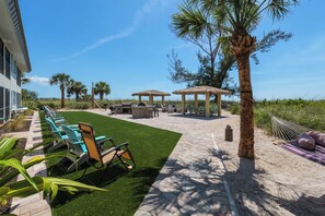 A patio area with outdoor seating, a barbecue grill, and a gazebo.