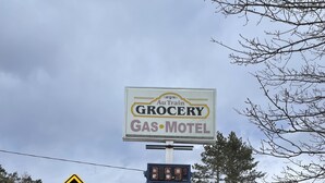 A sign for Au Train Grocery and Gas-Motel with a digital display showing 0.69. - Autrain Motel (Au Train)