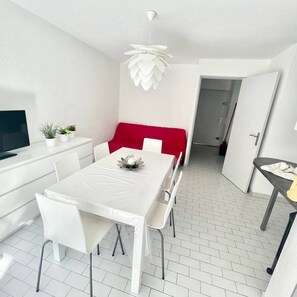 Enjoy meals in this stylish dining area with a table for four, a pendant light, and a comfortable bench.