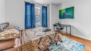 A bedroom with a bed, a desk, and a chair. - Modern 2BHK - 15 mins bus ride to Time Square, NYC (West New York)
