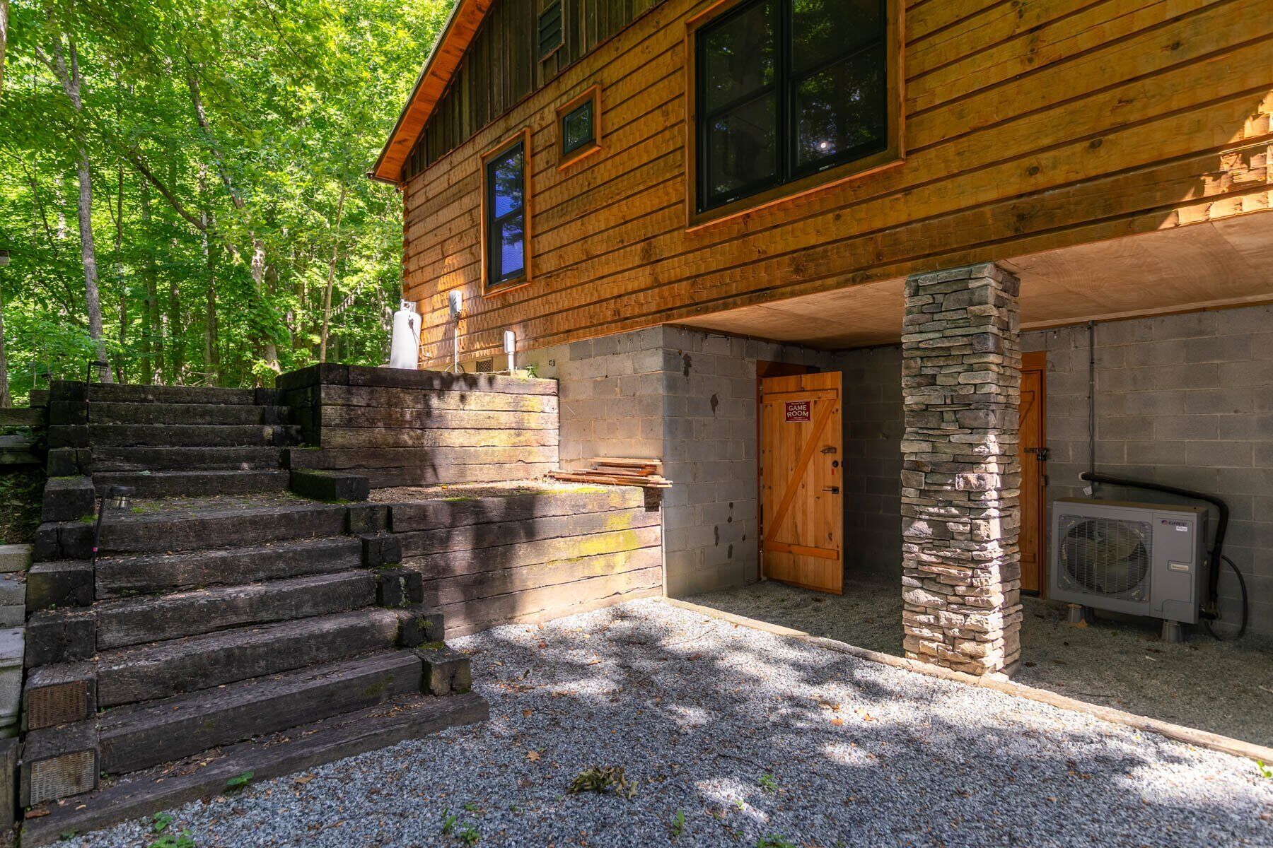 A wooden cabin with a stone pillar, a stone staircase, and a door labeled "Time Room".
