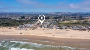 An aerial view of a coastal town with a beach, houses, and a marker indicating a specific location. - Coastal Haven w/ Large Rooftop Deck & Beach Access 🏖️ (Oceano)