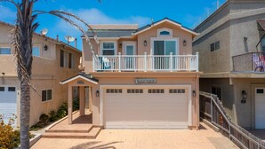 A two-story house with a balcony, a garage, and a sign that reads "BEACH HOUSE". - Coastal Haven w/ Large Rooftop Deck & Beach Access 🏖️ (Oceano)