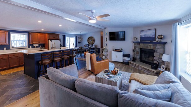 A modern living space with a kitchen, dining area, and a fireplace. - Private, Updated Baileys Harbor Home: The Roost (Baileys Harbor)