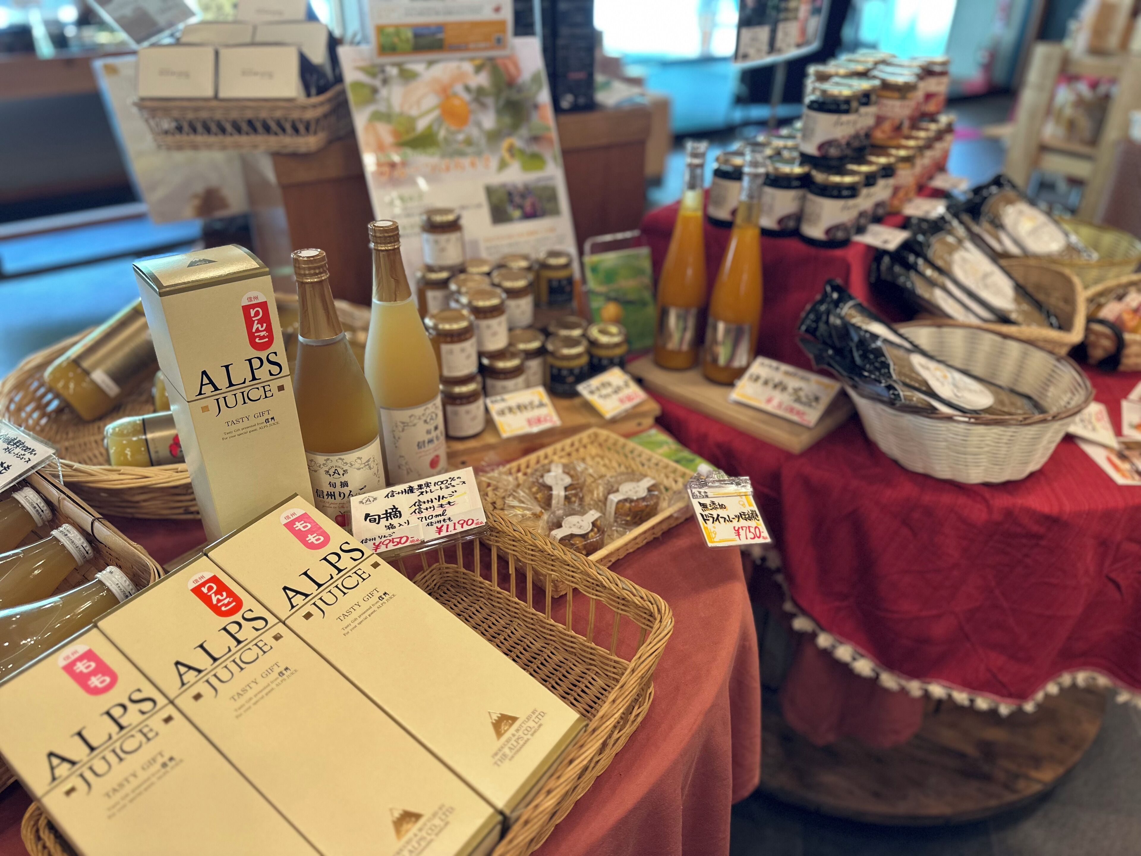 A display of ALPS juice boxes and bottles on a table with price tags.