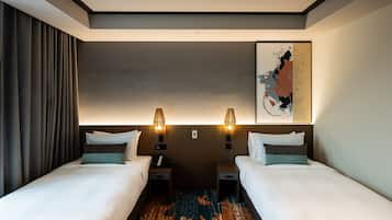 A hotel room with two beds, a large abstract artwork on the wall, and a patterned rug on the floor.