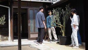 A traditional Japanese building with a tiled roof and a wooden entrance. - okatei (Tonosho)