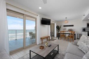 Un salon moderne comprenant un canapé, une table basse et un coin repas avec des chaises et une table.