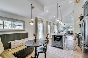 Enjoy cooking and dining in this spacious kitchen with a central island, oven, and dining area.