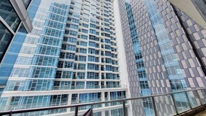 A modern high-rise building with a grid of windows and balconies. - Comfort Designed 1Br At Brooklyn Alam Sutera Apartment (South Tangerang)