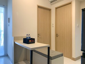 Relax in this stylish room with a comfortable table, flat-screen TV, and convenient amenities.