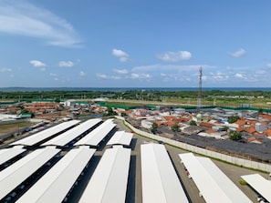 Industrial landscape with warehouses and green surroundings.