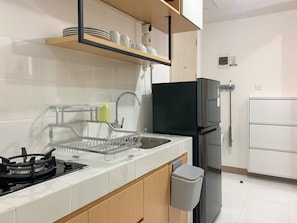 Enjoy cooking in this well-equipped kitchen with a refrigerator, sink, and gas stove.