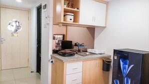 A compact kitchen with a built-in stove, a sink, and a refrigerator.
