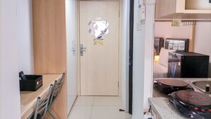 A compact kitchen with a refrigerator, stove, and sink.