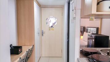 A compact kitchen with a refrigerator, stove, and sink.