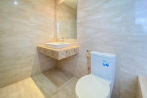 A bathroom with a marble sink, a toilet, and a large mirror. - Spacious And Comfort Living 2Br At Menteng Park Apartment (Jakarta)