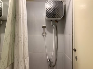 A shower with a wall-mounted unit labeled 'MODENA' and a handheld showerhead. - Minimalist And Nice Studio At Tokyo Riverside Pik 2 Apartment (Teluknaga)
