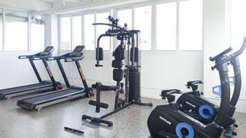 A gym with treadmills, a weight machine, and an elliptical.