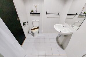 A modern bathroom with a toilet, bidet, and sink. - Good Deal 1Br Casa De Parco Apartment Near Aeon Mall (South Tangerang)