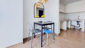 A modern kitchen with white cabinetry, a herringbone backsplash, and a built-in dishwasher. - Good Deal 1Br Casa De Parco Apartment Near Aeon Mall (South Tangerang)