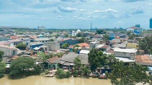Uma área urbana densamente povoada com diversos edifícios, incluindo casas residenciais e estruturas comerciais.