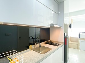 Apartment | Private kitchen | Full-size fridge, stovetop - Simply Look Studio Room At Patraland Urbano Apartment (Bekasi)