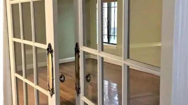 A room with a large white door with glass panels and a handle. - Cheerful cabin, tucked away, for nature lovers. (Decatur)
