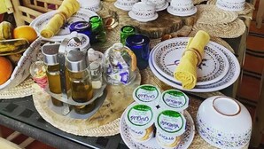 A table set with various dishes, including plates, bowls, and bottles, likely for a meal or event.