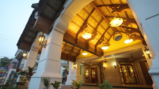 A hotel entrance with a wooden ceiling and multiple hanging lights. - Hotel Vijayetha (Nagercoil)