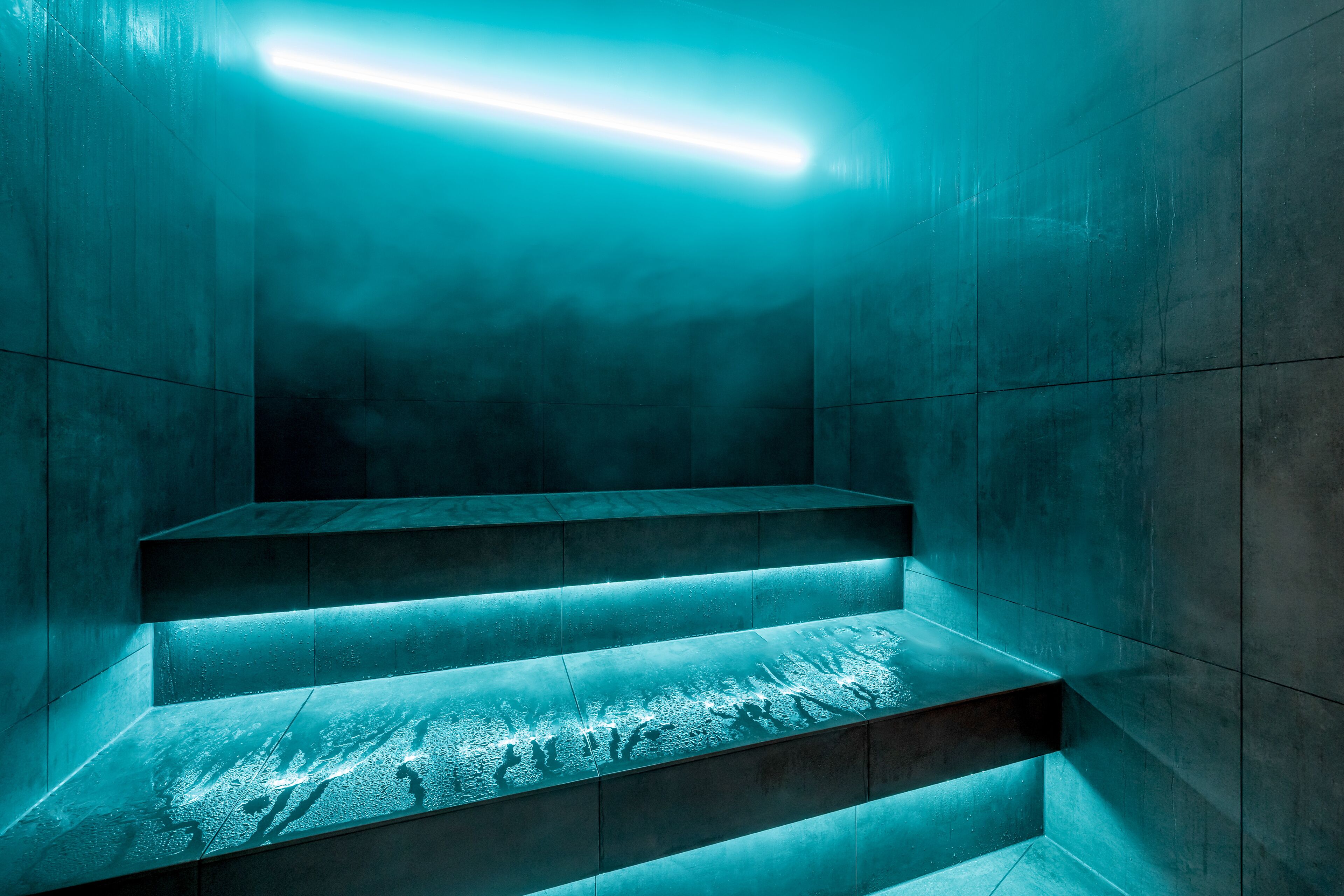 A set of stairs with a modern design, illuminated by underglow lighting.