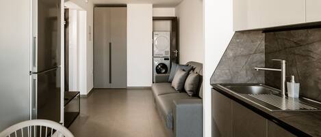 A modern kitchen with a built-in dishwasher, a sink with a faucet, and a countertop.