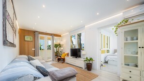 A modern bedroom with a bed, a TV, a desk, and a wardrobe. - Apartment 'Lagomar' with Private Terrace, Wi-Fi and Air Conditioning (Alcudia)