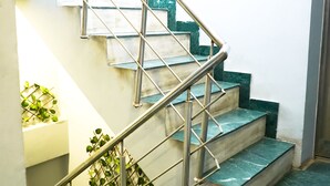 A staircase with metal railings and green marble steps. - Roomshala 028 Blu Lagoon (New Delhi)