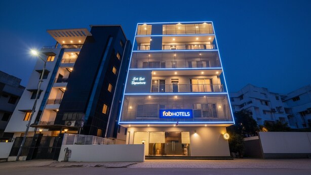 A multi-story hotel with a modern design, featuring a prominent 'fabHOTELS' sign on the ground floor. - Fabhotel Pearl City (Hyderabad)