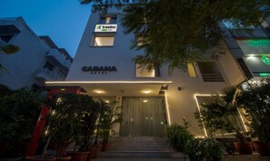 The exterior of the Cabana Hotel with a modern design, featuring a prominent entrance with steps and potted plants. - Treebo Cabana (New Delhi)