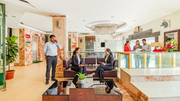 A hotel lobby with a reception desk, seating area, and a large chandelier. - FabHotel Marble Arch - Nr. Karol Bagh Market (New Delhi)