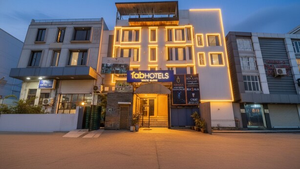 A modern building with a prominent 'FabHotels' sign, featuring a large entrance and multiple windows. - Fabhotel White Klove (New Delhi)