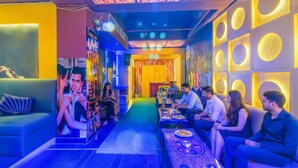 A vibrant lounge area with seating and tables, a patterned ceiling, and a central walkway. - Fabhotel White Klove (New Delhi)