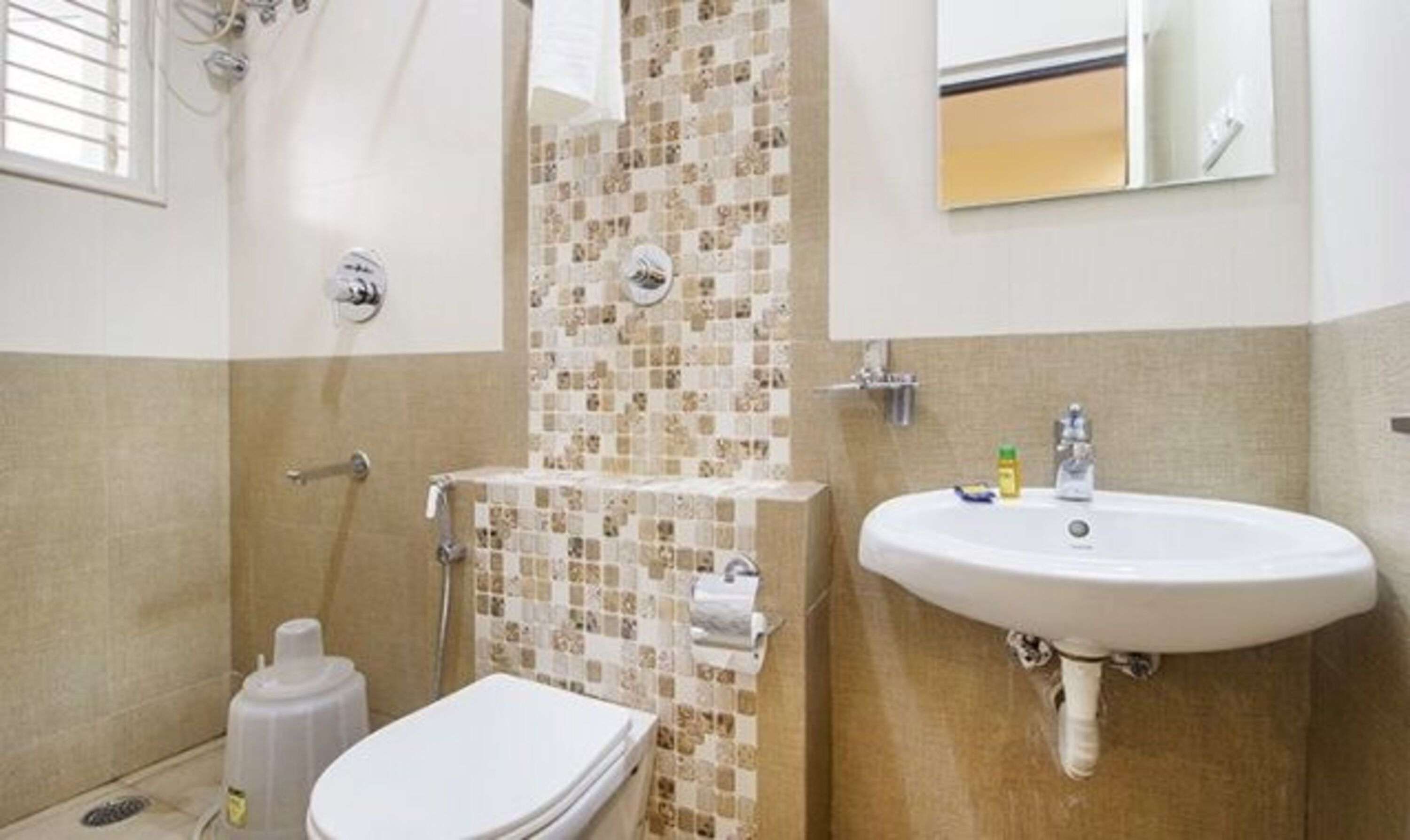 A bathroom with a toilet, sink, and shower.