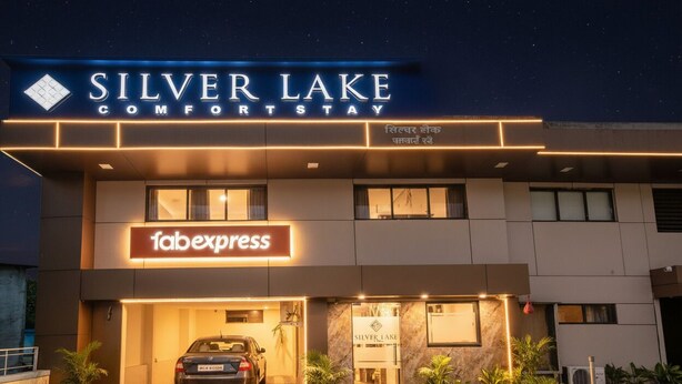 A hotel named Silver Lake ComfortStay with a 'Tabexpress' sign, a car parked in front, and potted plants around. - FabHotel Silver Lake (Mumbai)