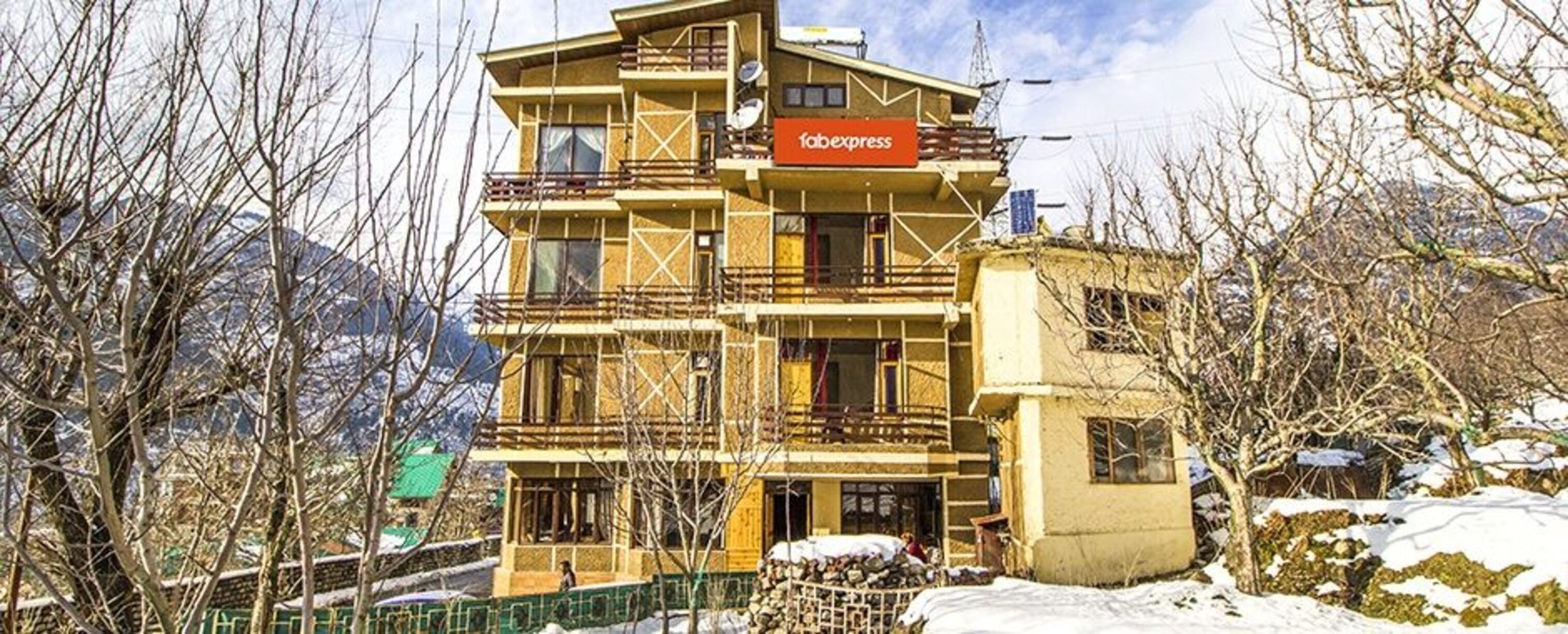 A multi-story building with a sign reading "fabexpress" on the facade.
