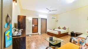 A hotel room with a bed, a desk, a chair, a ceiling fan, and a sign indicating the room is clean. - FabHotel K7 Trends With Pool, Baga Beach (Calangute)